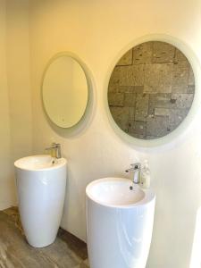 a bathroom with a sink and two mirrors at Cabaña en Tapalpa, Cabaña Monarca in Tapalpa +17 photos