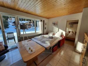 a bedroom with a bed and a table with a view at Apartment Ferienwohnung Montana-Staub by Interhome in Lenzerheide