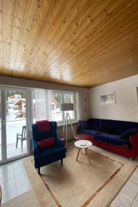 a living room with two blue couches and a table at Apartment Ferienwohnung Montana-Staub by Interhome in Lenzerheide