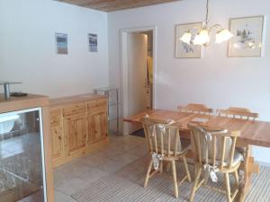 a kitchen and dining room with a wooden table and chairs at Apartment Ferienwohnung Montana-Staub by Interhome in Lenzerheide