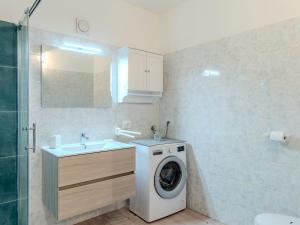 a bathroom with a washing machine and a sink at Apartment Welcome 2 Riva by Interhome in Riva del Garda