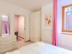 a bedroom with a white bed and a window at Apartment Welcome 2 Riva by Interhome in Riva del Garda