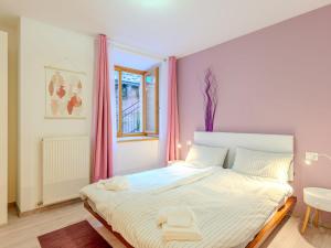 a bedroom with a large bed with pink curtains at Apartment Welcome 2 Riva by Interhome in Riva del Garda +33 photos