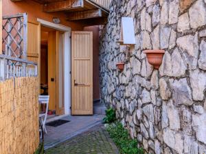 a stone building with a door and a stone wall at Apartment Welcome 2 Riva by Interhome in Riva del Garda