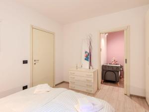 a bedroom with a bed and a dresser and a mirror at Apartment Welcome 2 Riva by Interhome in Riva del Garda