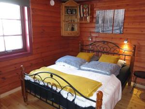 a bedroom with a bed in a room with wooden walls at Holiday Home Ørnefjell - SOW162 by Interhome in Åseral
