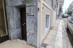 a building with a door on the side of a street at M&S Apartments Athens in Athens