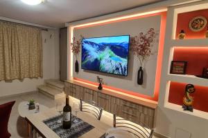 a living room with a television on a wall at M&S Apartments Athens in Athens