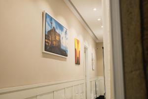 a hallway with paintings on the walls of a building at Residence Black & White in Naples