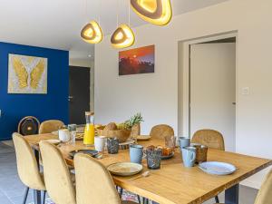 a dining room with a wooden table and chairs at Holiday Home Villa du Golf by Interhome in Baden