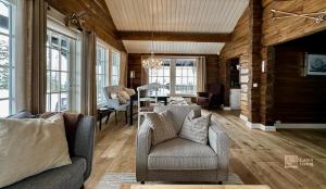 a living room with a couch and a dining room at Fantastic cabin on Hafjell ski inout in Hafjell