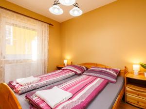 a bedroom with a bed with two pillows and a window at Apartment Andreas by Interhome in Balatonőszöd