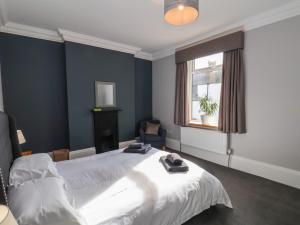 a bedroom with a white bed and a window at 11 Highfield in Scarborough