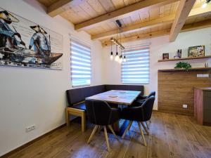 a dining room with a wooden table and chairs at Chalet Pod lesem by Interhome in Smržovka