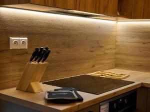a kitchen counter with a knife block and a stove at Chalet Pod lesem by Interhome in Smržovka +50 photos