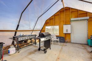 a greenhouse with a grill in the middle of it at Malta Vacation Rental about 2 Mi to Town! in Malta