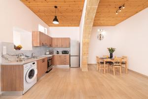 a kitchen with a washer and a table in it at M&K Traditional House in Theologos