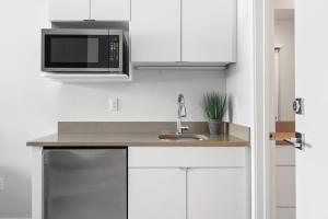 a kitchen with a sink and a microwave at Perfect Peak, Unit 2B in Fraser
