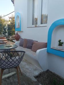 a living room with a couch and a table at PERIVOLI 1-CHORA(5min away from the center by car) in Agkidia