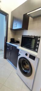 a kitchen with a washing machine in a kitchen at Archangelos SKY Junior Apartment in Archangelos