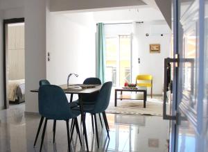 a dining room with a table and chairs at Patras Cozy Nest in the Vibrant City Center in Patra