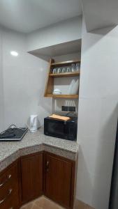 a kitchen with a counter top with a microwave at Bishram Homes in Pātan