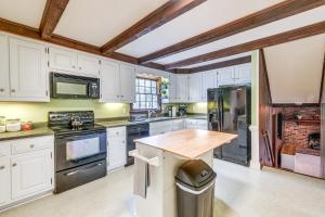 a kitchen with white cabinets and a wooden counter top at Richmond Vacation Rental about 10 Mi to Downtown! in Richmond