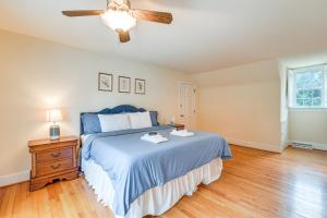a bedroom with a blue bed and a ceiling fan at Richmond Vacation Rental about 10 Mi to Downtown! in Richmond