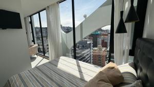 a bedroom with a bed and a view of a city at Nueva Suite Vista VIP Quito in Quito
