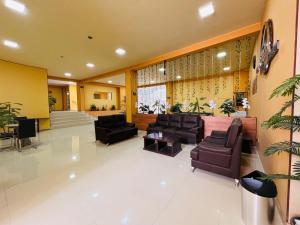 a lobby with couches and chairs in a building at HGA-Perla-Spa in La Paz +56 photos