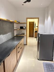 a kitchen with a stainless steel refrigerator in it at Andaz Luxe Apartment. in Indore
