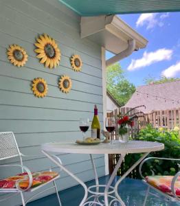 a patio with a table and two glasses of wine at Peaceful Private Cottage, Walk to Park & 5 Mins to Downtown in Nashville