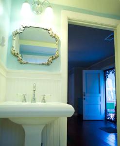 a bathroom with a sink and a mirror on the wall at Truly Central Private Guest House in Nashville