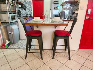 a kitchen with a table and two chairs and a table and a kitchen with at Ti Brico Gros Islet Bungalow in Gros Islet