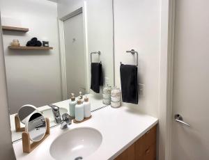 a bathroom with a sink and a mirror at City Views & Downtown Bliss in Portland