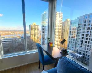 a desk and chairs in a room with a large window at City Views & Downtown Bliss in Portland