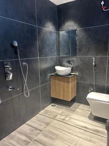 a bathroom with a sink and a toilet and a shower at Andaz Luxe Apartment. in Indore