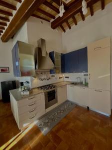 eine große Küche mit weißen Arbeitsflächen und blauen Schränken in der Unterkunft GG Apartments Assisi in Assisi