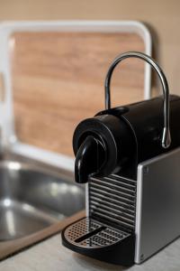 a black toaster sitting on top of a counter at Unique Modern Apartment in Alexandroupoli