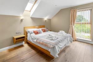 a bedroom with a bed and a window at Middleton Cottages in Yarm