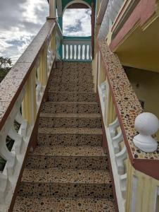 a stairway leading up to a building with a stair case at Grand Vue Apartment Vieux Fort in Vieux Fort