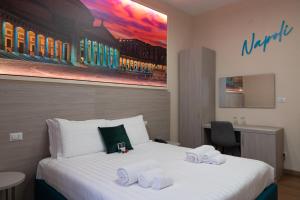 a hotel room with a bed with towels on it at THE SUN HOTEL BOUTIQUE NAPOLI in Naples