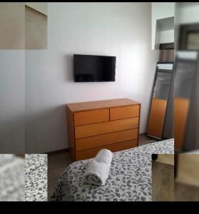 a bedroom with a bed and a dresser with a towel at Urbain place masira in Casablanca