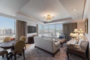 a living room with a couch and a table at Raffles Makkah Palace in Makkah