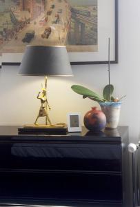 a table with a lamp and a plant on it at Handy Studio near Nato in Brussels