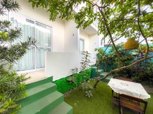 a garden with green stairs and a bench at Pousada Linda flor in Morro de São Paulo