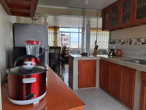 een keuken met een rode blender op een aanrecht bij Departamento de 3 pisos a 9 cuadras de la plaza in Ayacucho