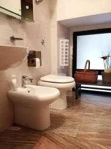 a bathroom with a toilet and a sink at Sweet Sweet Home in Tolve