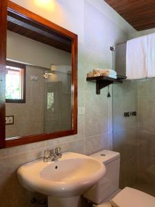 a bathroom with a sink and a toilet and a mirror at Panorama B&B in Machu Picchu