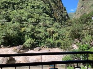 a view of a mountain with trees and a river at Panorama B&B in Machu Picchu